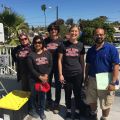 Group of five people standing on a rooftop with technical equipment, four wearing "San Diego State University" T-shirts.