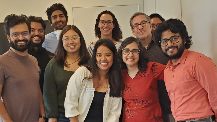 Dr. Nabamallika Dehingia (center, wearing white cardigan) at her dissertation defense