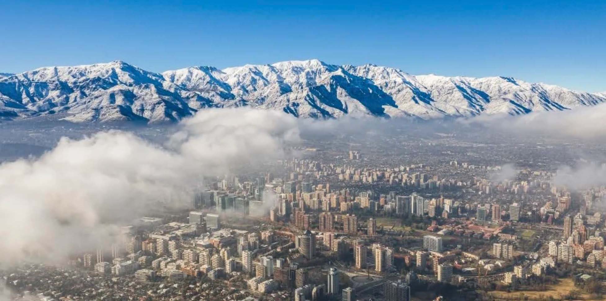 Overviewing a city with the Andes Mountains looming in the background