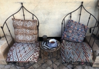 Two chairs with a tea cup in between them