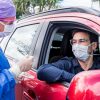 nurse talking to someone in car in a mask