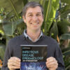 Headshot of Eyal Oren with the new textbook Infectious Disease Epidemiology: An Introduction