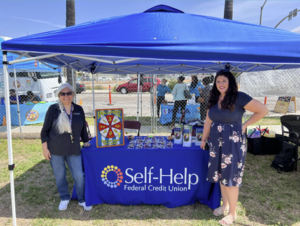 Self Help Credit Union Booth With two SDSU Faculty standing by it. 